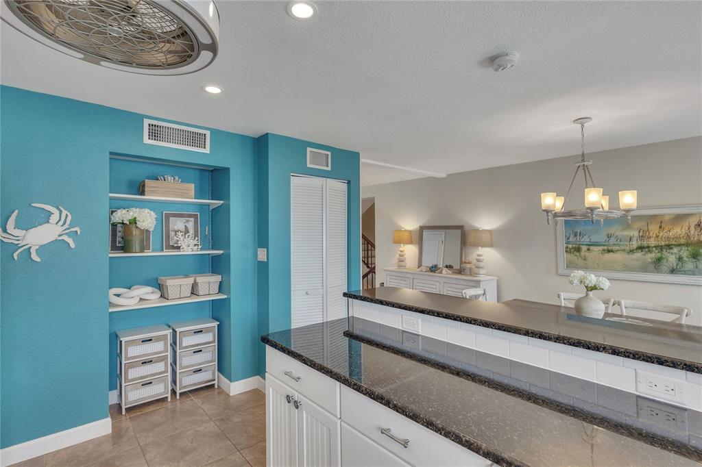 Undisclosed Address Clearwater, FL 33767 - Photo 17 of 39 a kitchen with kitchen island a stove and a refrigerator