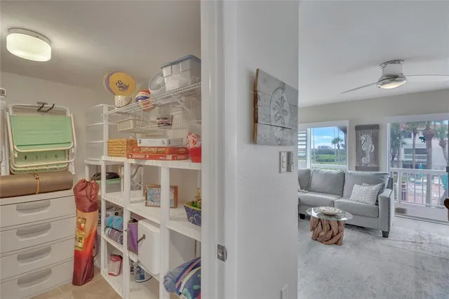a living room with furniture cabinets and a window
