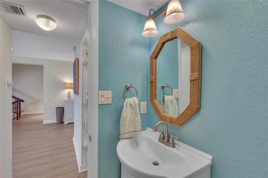 Undisclosed Address Clearwater, FL 33767 - Photo 19 of 39 a bathroom with a sink and a mirror