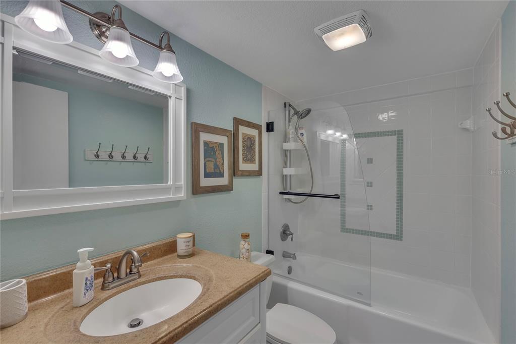 Undisclosed Address Clearwater, FL 33767 - Photo 26 of 39 a bathroom with a granite countertop sink toilet and shower