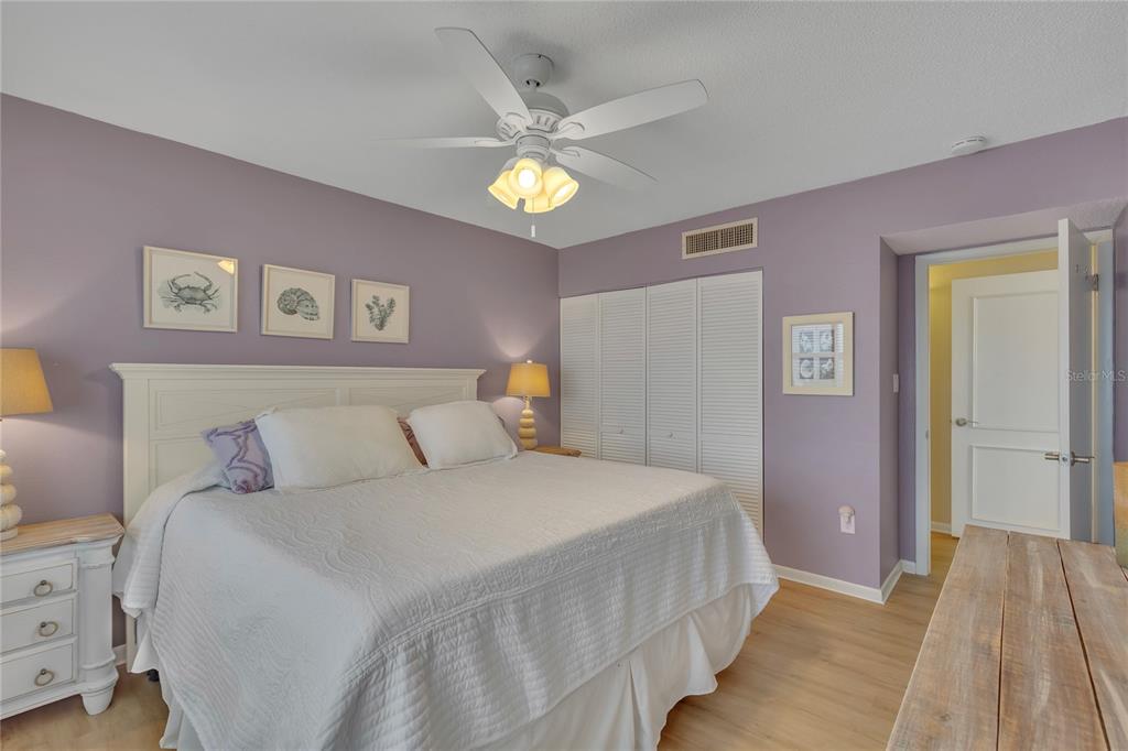 Undisclosed Address Clearwater, FL 33767 - Photo 28 of 39 a bedroom with a bed and a chandelier