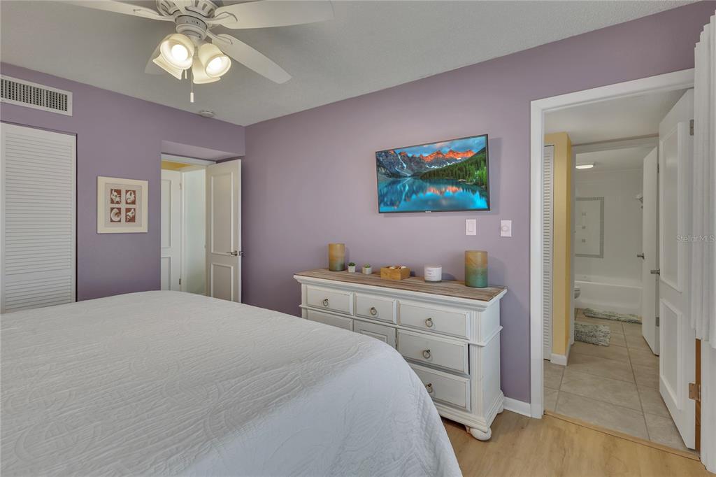 Undisclosed Address Clearwater, FL 33767 - Photo 29 of 39 a bedroom with a bed and a chandelier