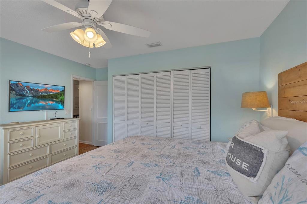 Undisclosed Address Clearwater, FL 33767 - Photo 32 of 39 a bedroom with a bed and a chandelier