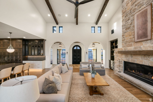 4871 South Homestead Way Washington, UT 84780 - Photo 15 of 151 Living area with arched walkways, light wood-style flooring, a fireplace, built in shelves, and recessed lighting