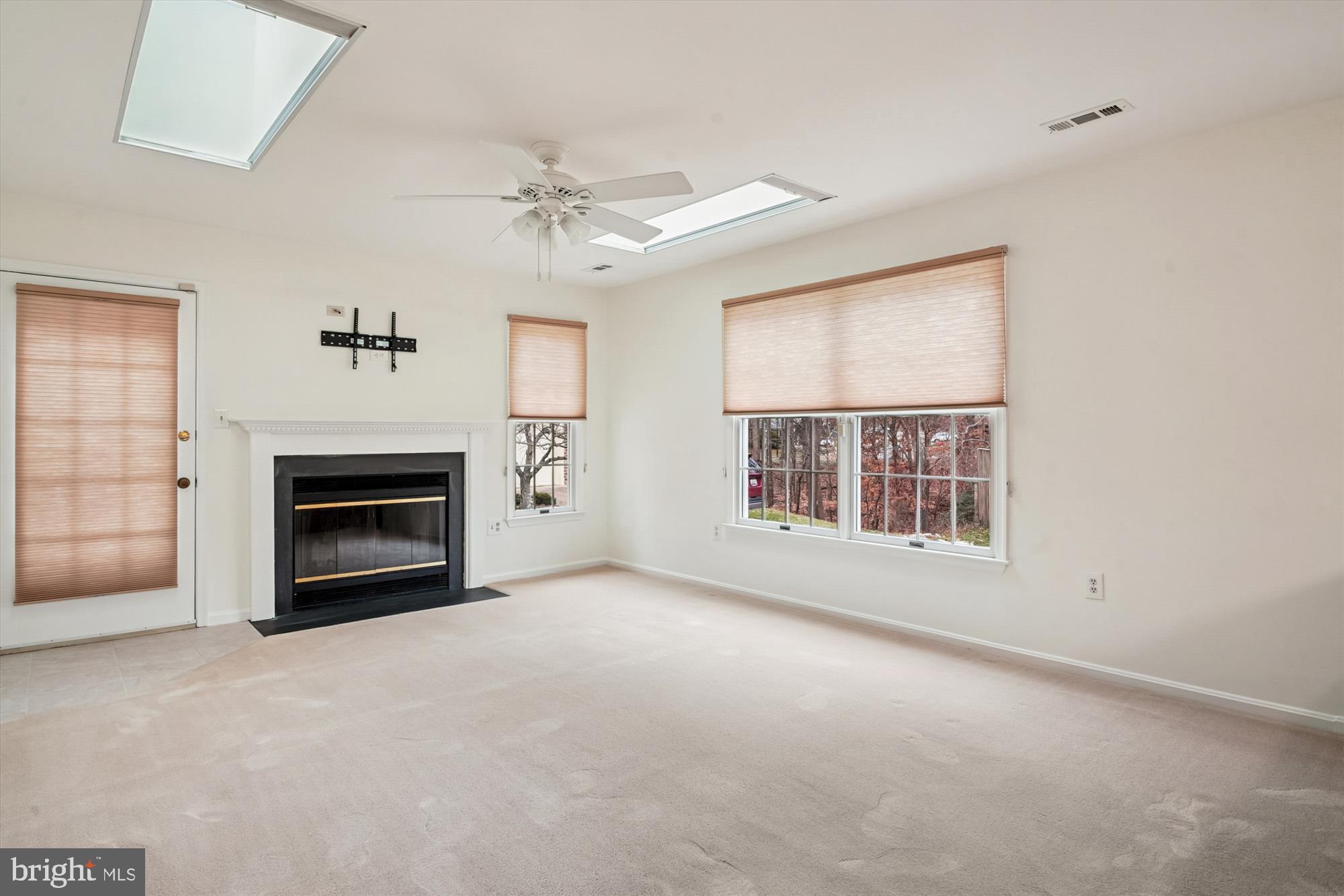 524 Coover Road Annapolis, MD 21401 - Photo 15 of 67 an empty room with windows fireplace and fan