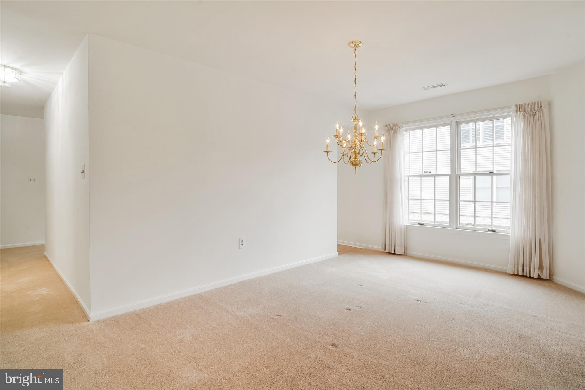 524 Coover Road Annapolis, MD 21401 - Photo 9 of 67 a view of an empty room with chandelier and a window