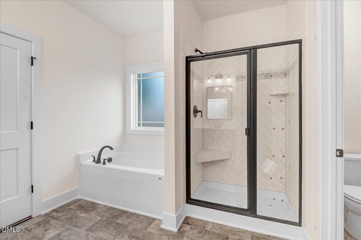 254 Galway Road Lillington, NC 27546 - Photo 23 of 35 a bathroom with a bathtub and shower