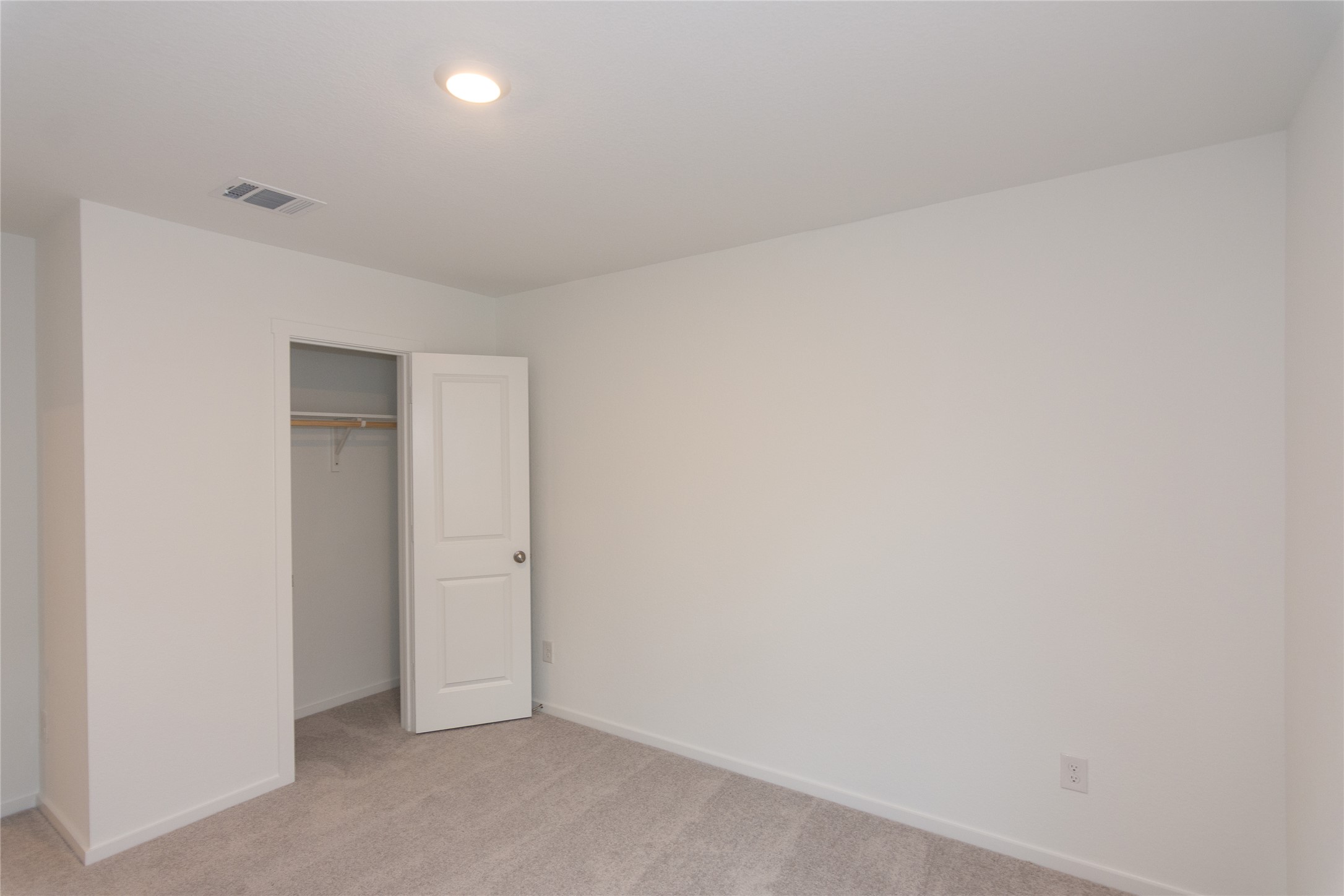 149 Star Packer Lane Jarrell, TX 76537 - Photo 21 of 30 A well-lit bedroom with fresh carpet and a convenient closet awaits customization.