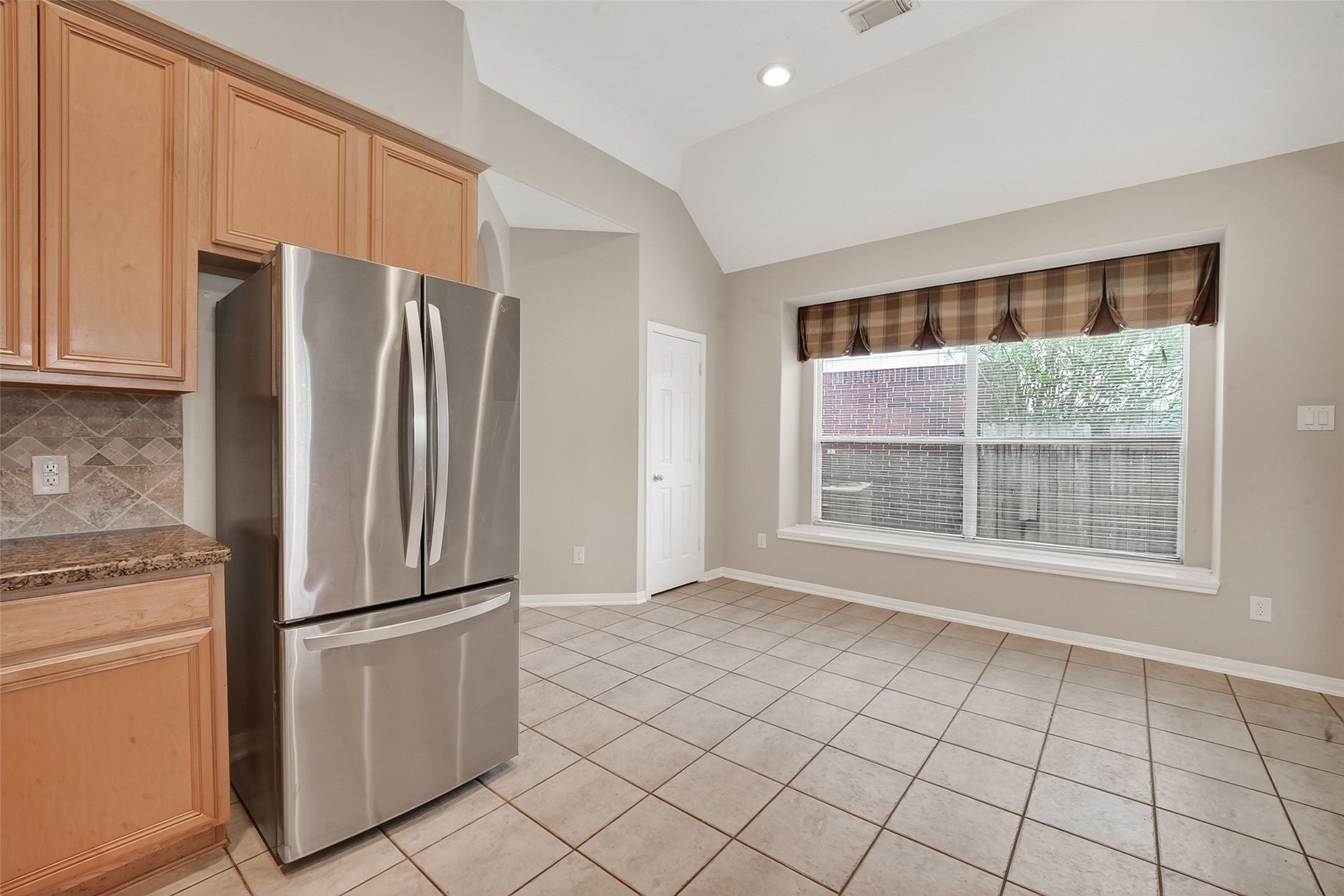 14308 Rocky Briar Lane Rosharon, TX 77583 - Photo 16 of 46 a metallic refrigerator freezer sitting in a kitchen