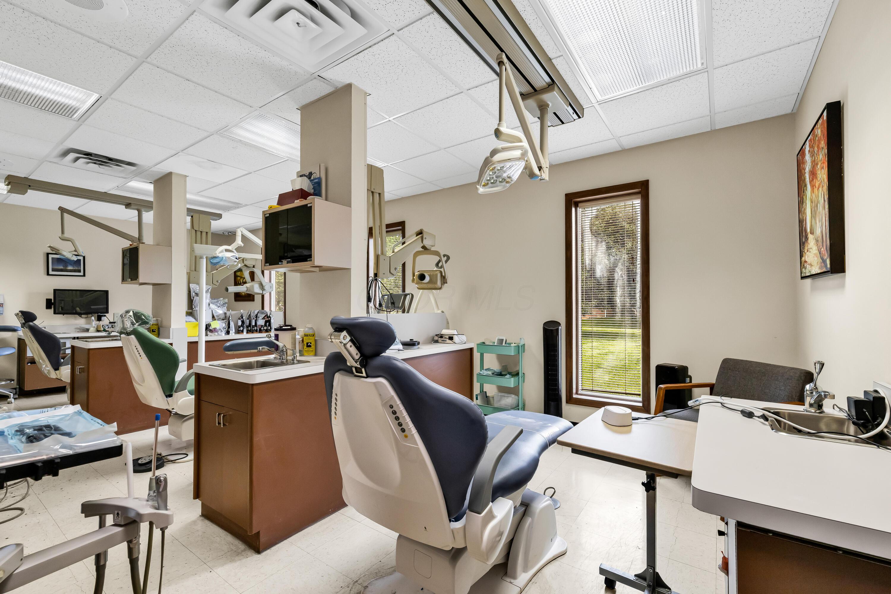 1240 Crescent Heights Road Marion, OH 43302 - Photo 43 of 60 • Neutral vinyl flooring • Ivory painted walls • Acoustic ceiling tiles • Fluorescent lighting • Enclosed vanity with single bowl, stainless steel sinktop • Divider • Lighting & equipment do not remain • Plumbed for oxygen & nitrogen