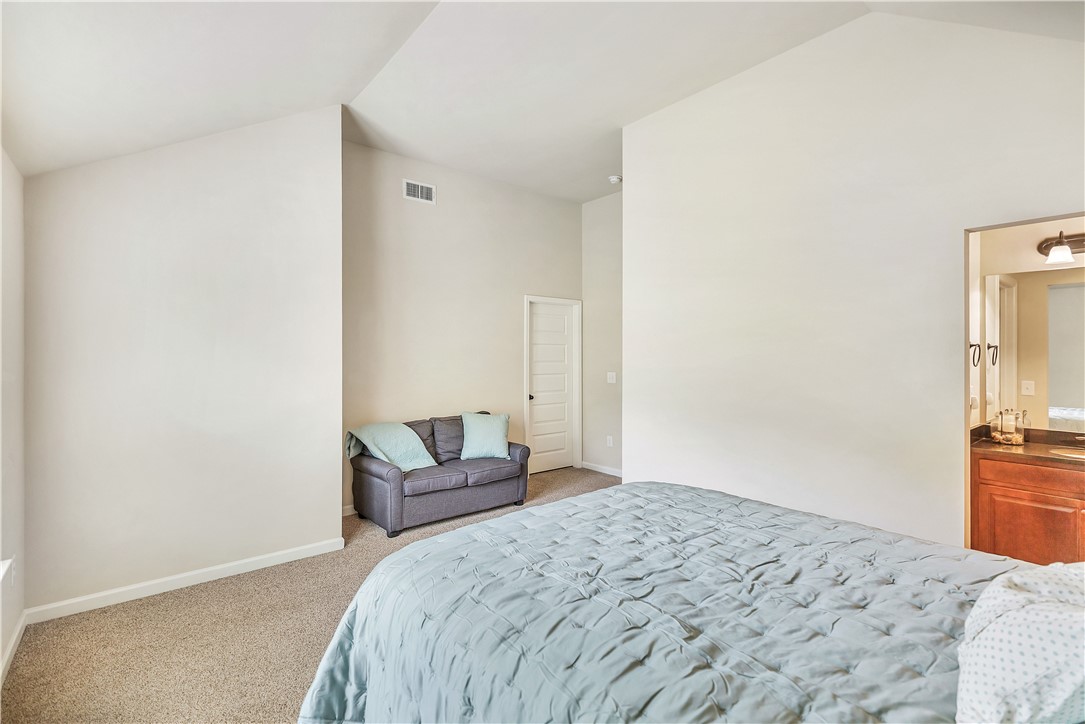 144 Buckland Drive Anderson, SC 29621 - Photo 22 of 48 A primary bedroom with vaulted ceilings and plush carpet, offering a private entrance to the primary bathroom.