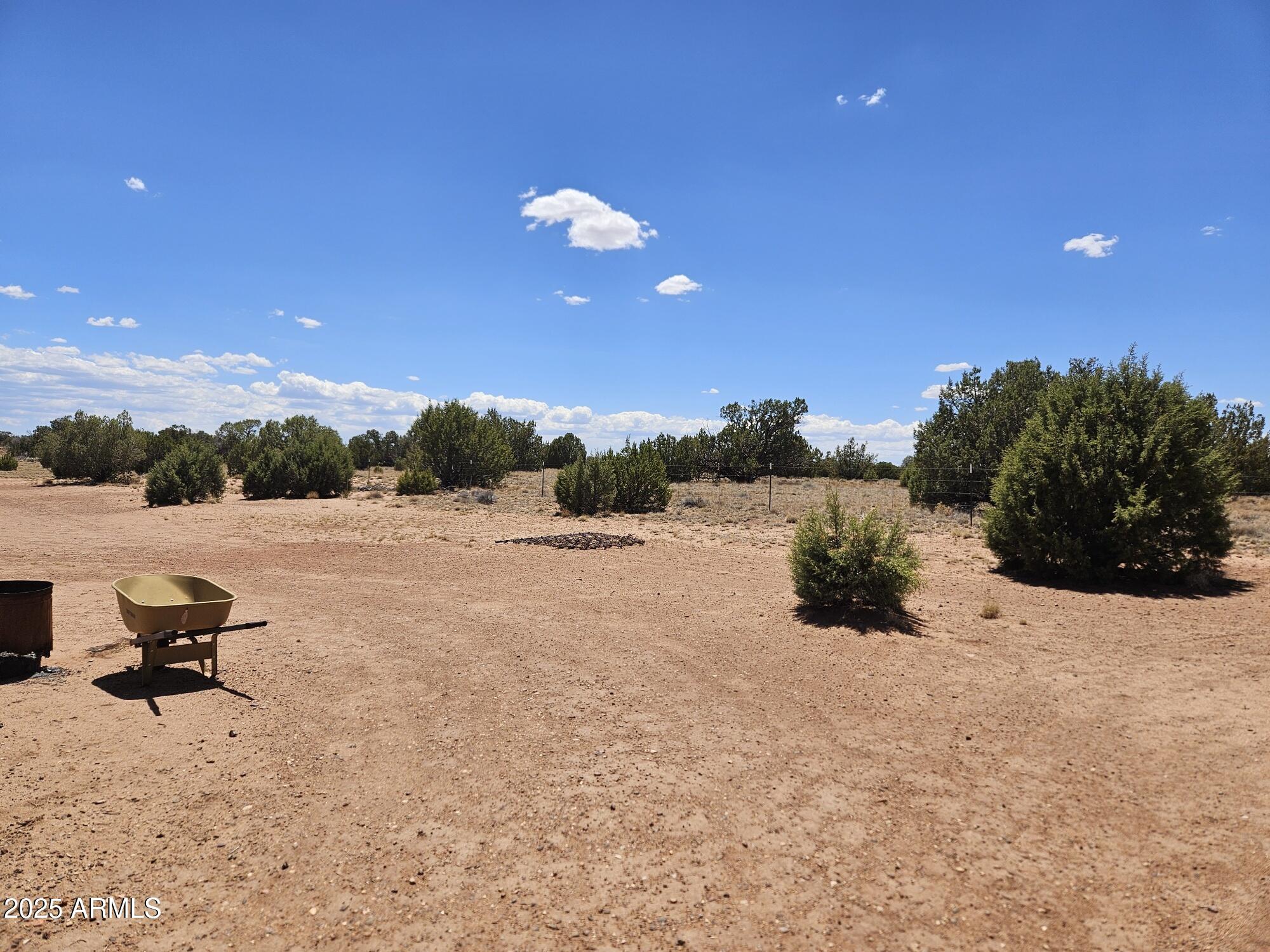 27 N9183, Unit 72 Concho, AZ 85924 - Photo 6 of 9 a view of a terrace with a bench and trees around