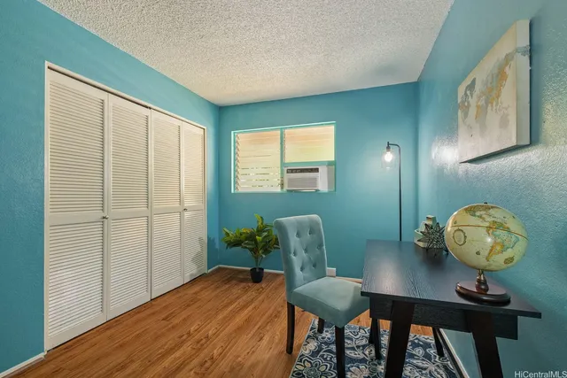 a view of a workspace room with furniture and wooden floor
