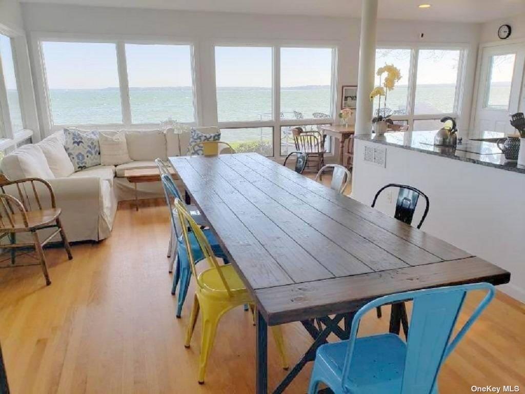11 Beach Road Riverhead, NY 11947 - Photo 16 of 34 a living room with dining table furniture and a large window