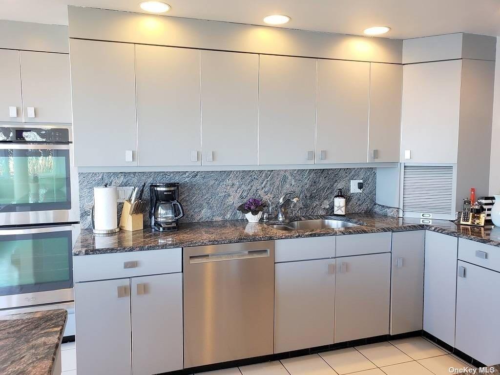 11 Beach Road Riverhead, NY 11947 - Photo 20 of 34 a kitchen with stainless steel appliances granite countertop a sink and cabinets