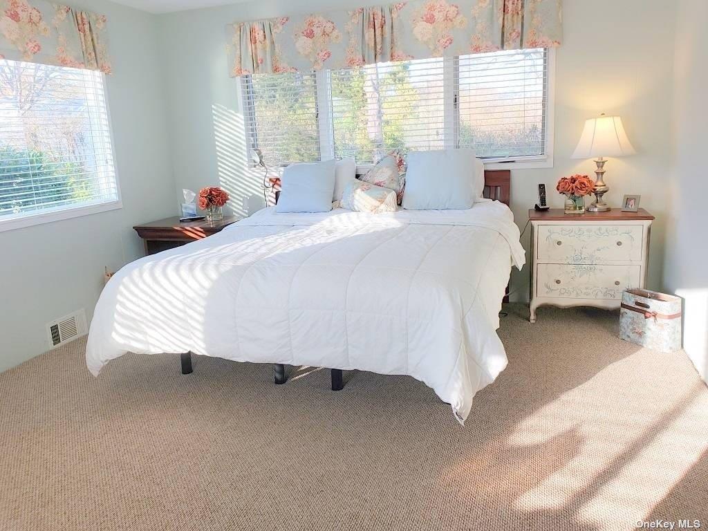 11 Beach Road Riverhead, NY 11947 - Photo 22 of 34 a bedroom with bed and window