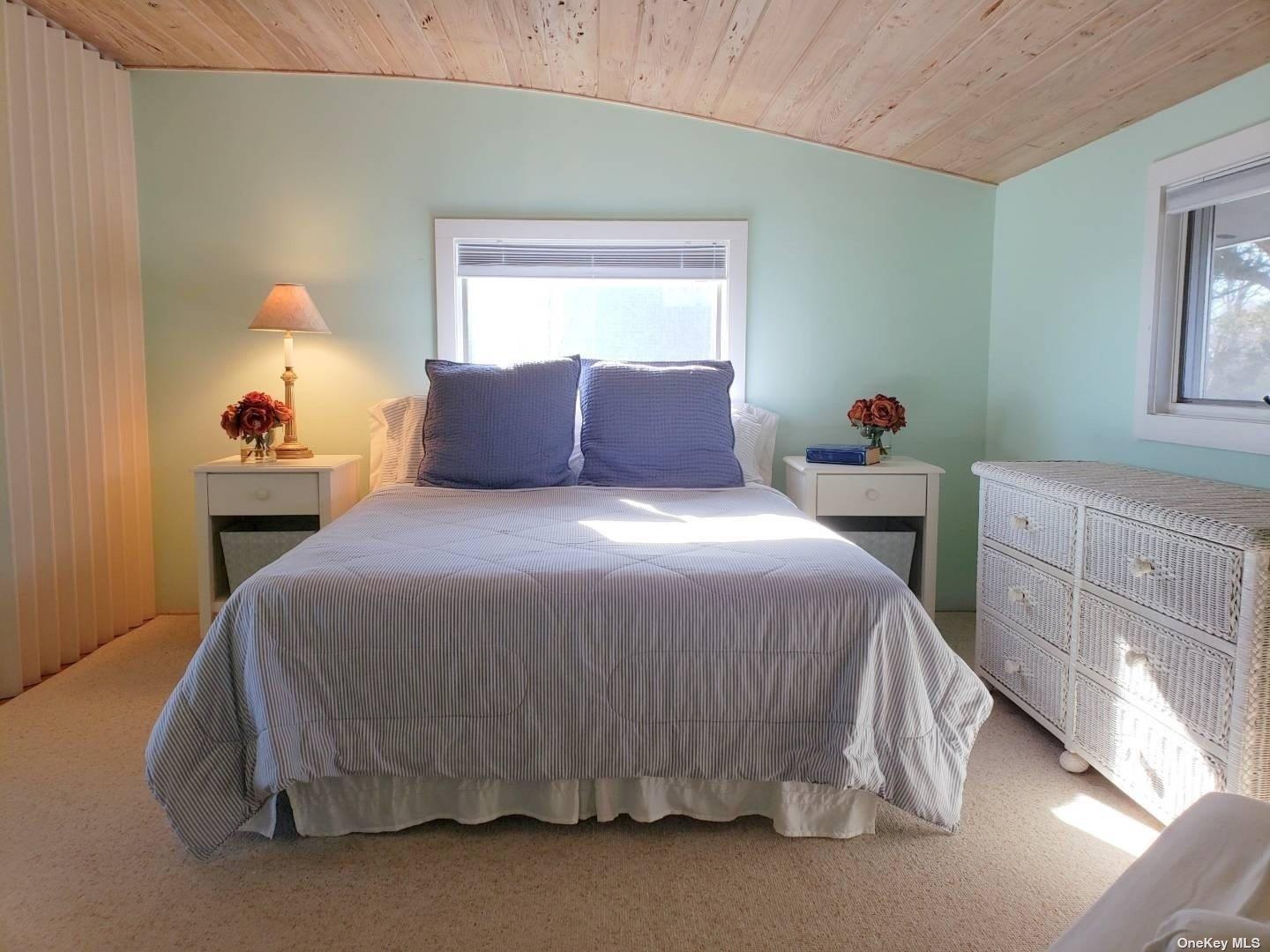 11 Beach Road Riverhead, NY 11947 - Photo 26 of 34 a bed sitting in a bedroom next to a window