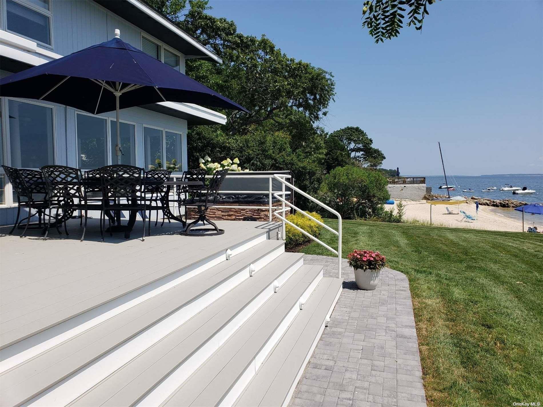 11 Beach Road Riverhead, NY 11947 - Photo 3 of 34 a view of a chairs and table in patio with a barbeque