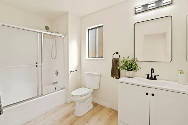 a bathroom with a toilet sink and shower