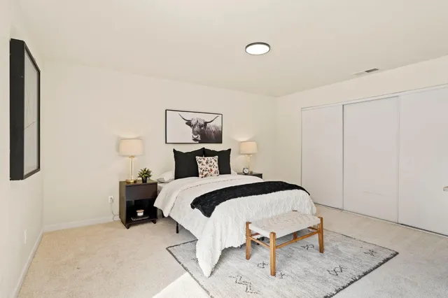 a bedroom with a bed and a table