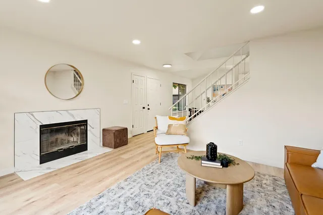 a living room with furniture and a fireplace