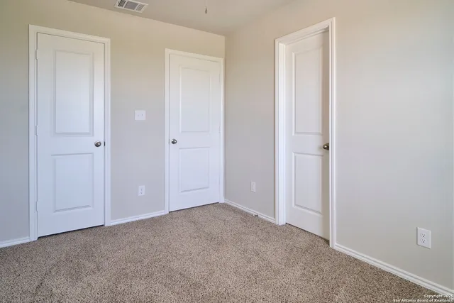 a view of an empty room and closet area