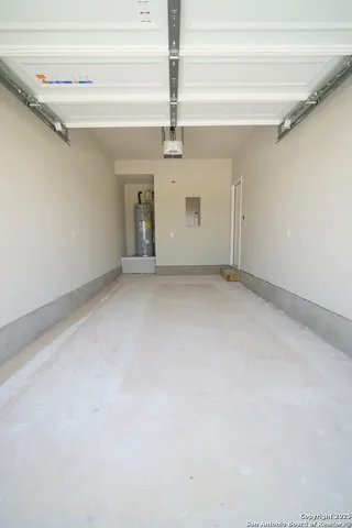 a view of a big room with windows and a ceiling fan