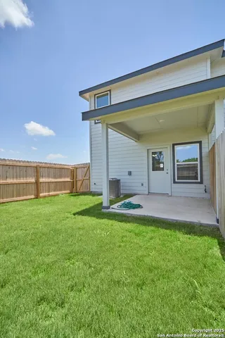 a view of a house with a backyard
