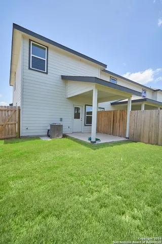a view of a house with backyard and porch