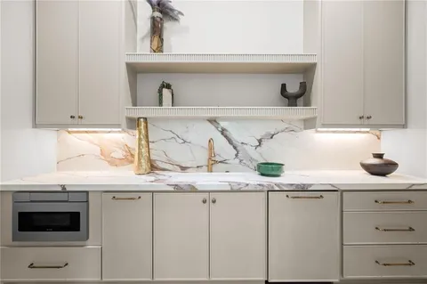 a kitchen with white cabinets and a sink