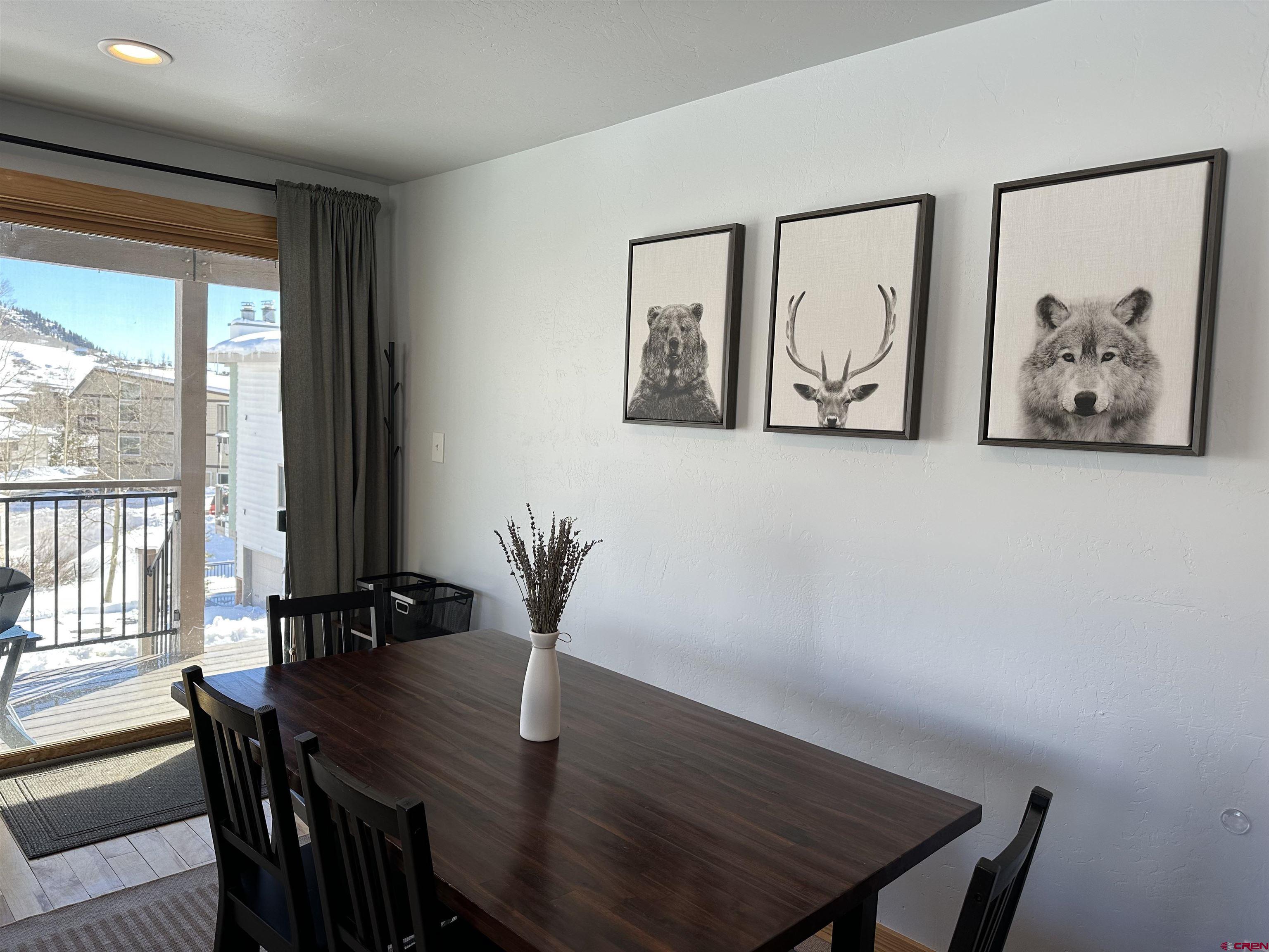 755 Gothic Road, Unit 2 Crested Butte, CO 81225 - Photo 13 of 36 a view of a dining room with furniture a potted plant and wooden floor