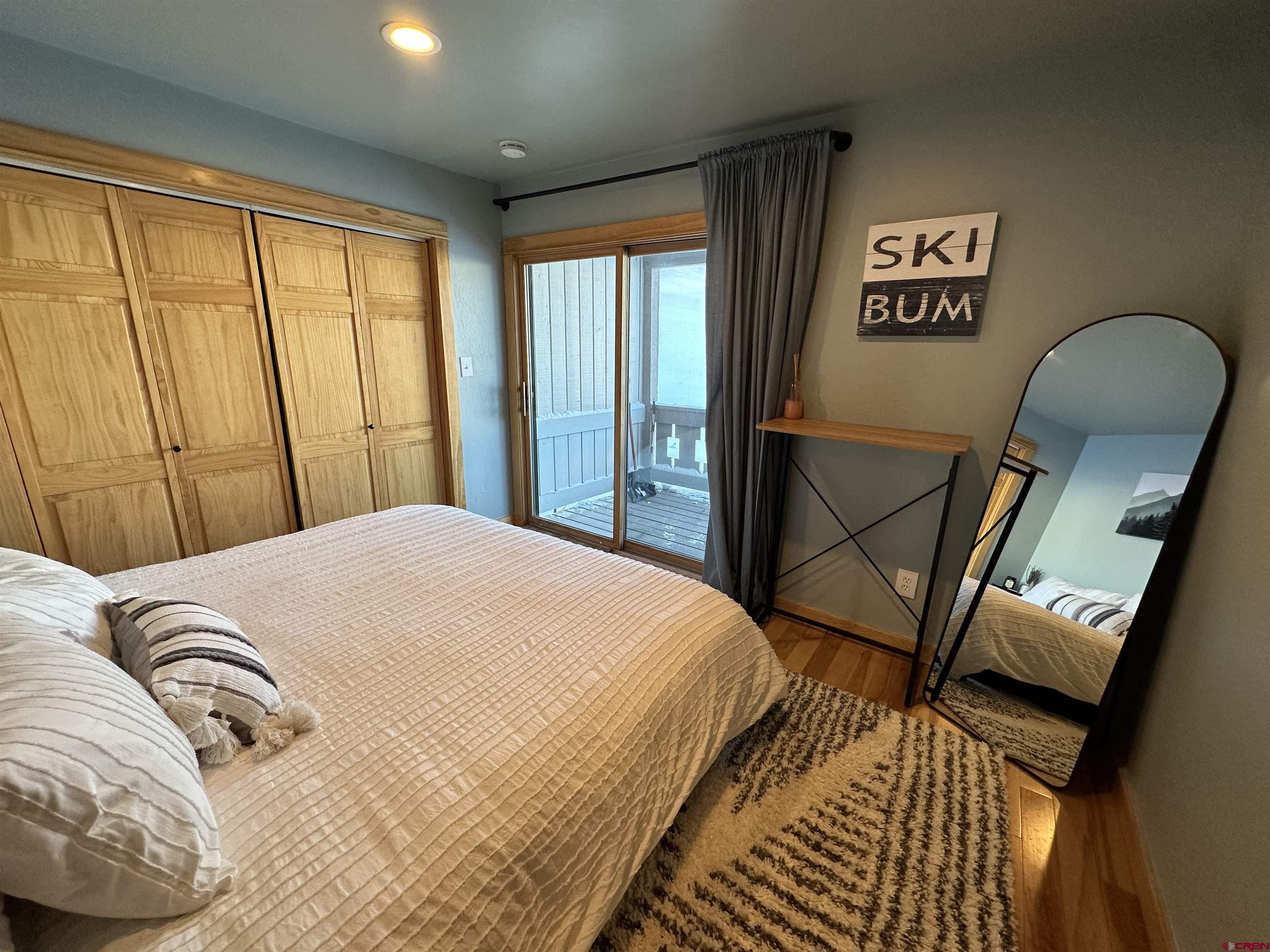 755 Gothic Road, Unit 2 Crested Butte, CO 81225 - Photo 14 of 36 a bedroom with a bed and a large window