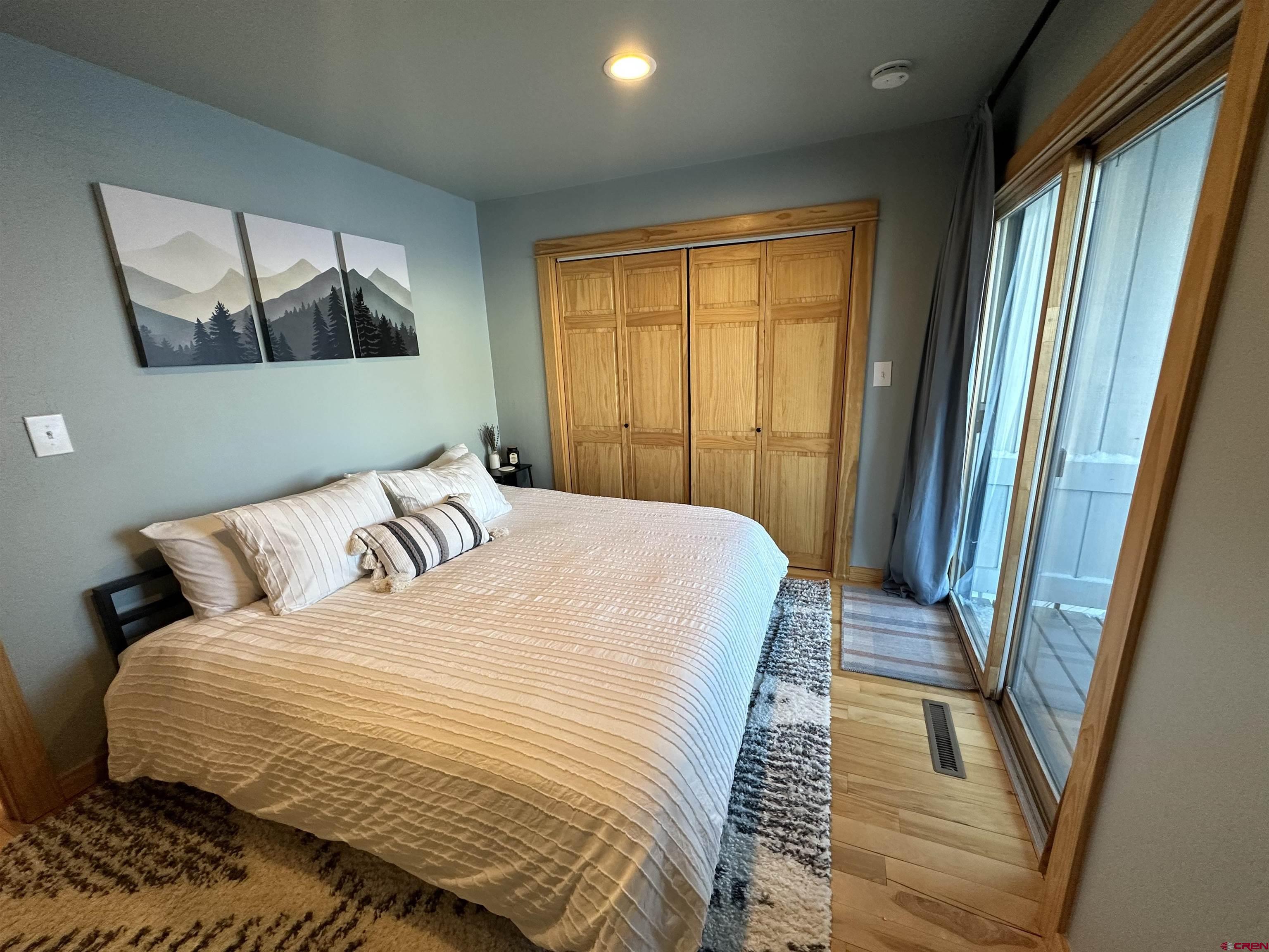 755 Gothic Road, Unit 2 Crested Butte, CO 81225 - Photo 16 of 36 a bedroom with a bed and a large window