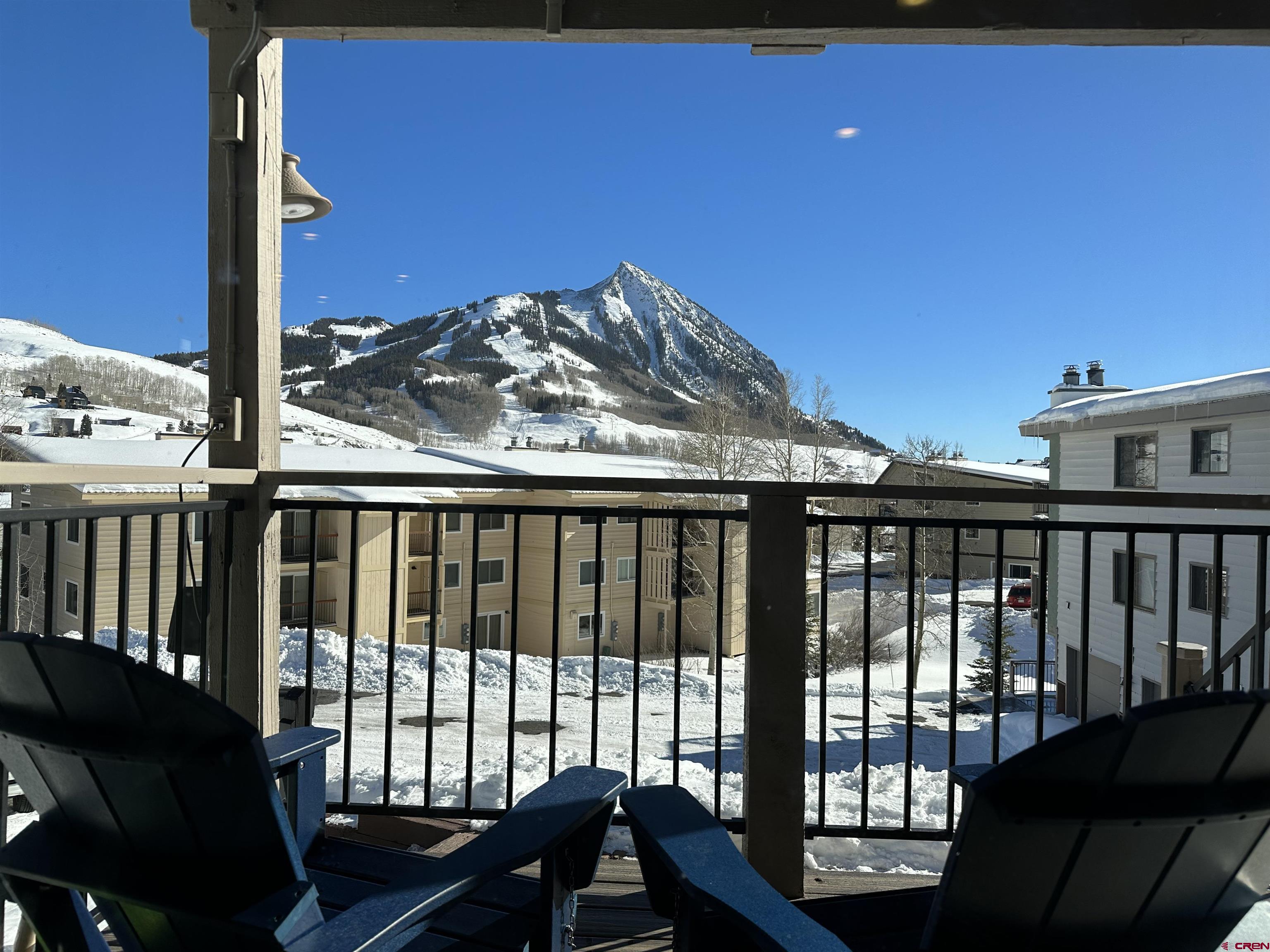 755 Gothic Road, Unit 2 Crested Butte, CO 81225 - Photo 2 of 36 a view of a balcony with chair and table