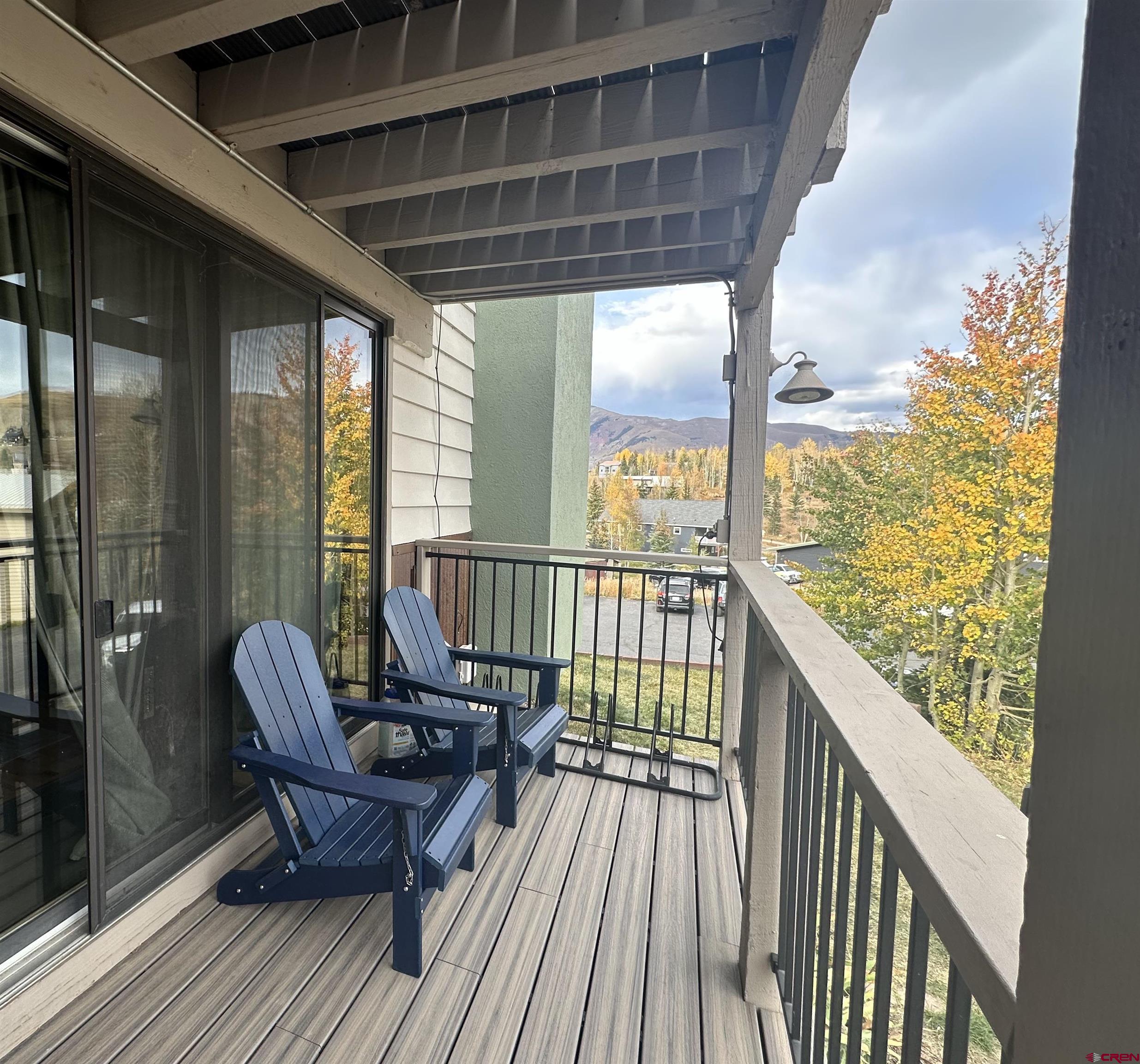 755 Gothic Road, Unit 2 Crested Butte, CO 81225 - Photo 32 of 36 a view of a balcony with furniture and wooden floor