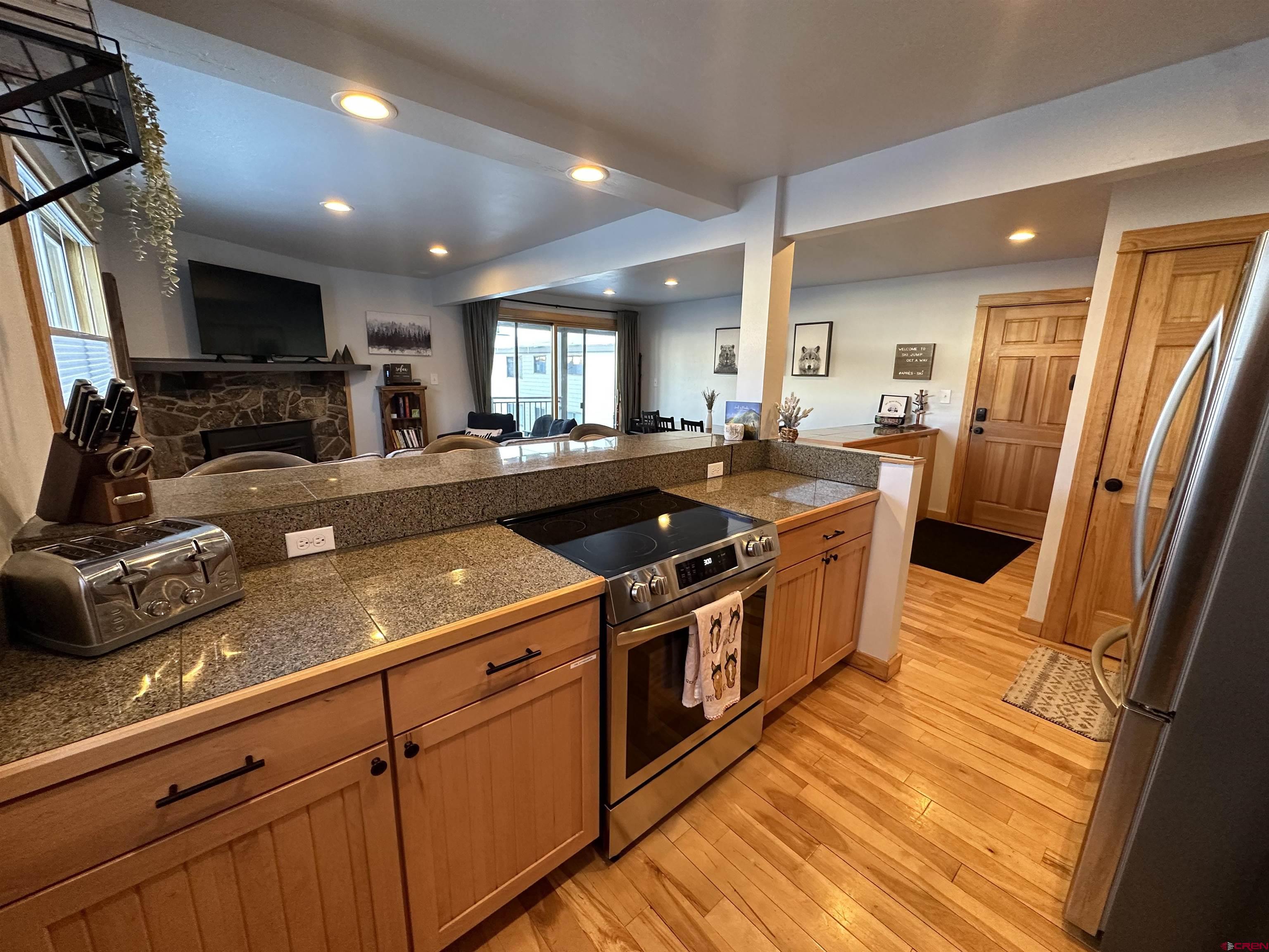 755 Gothic Road, Unit 2 Crested Butte, CO 81225 - Photo 9 of 36 a kitchen with a stove a sink and a refrigerator