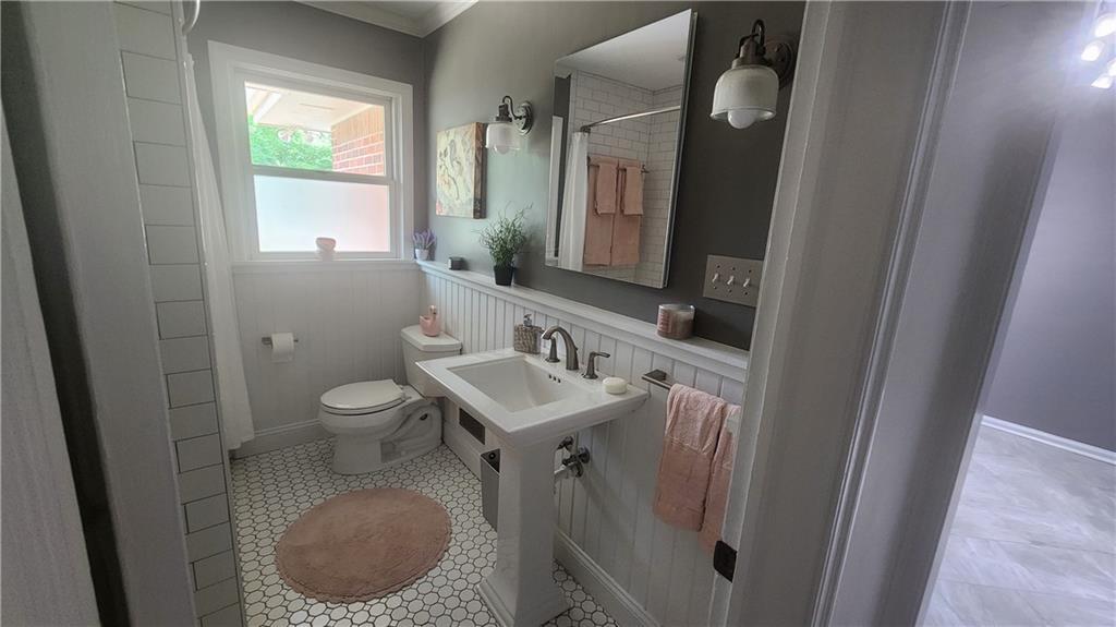2132 Clairmont Road Decatur, GA 30033 - Photo 8 of 11 a bathroom with a sink a toilet and a mirror