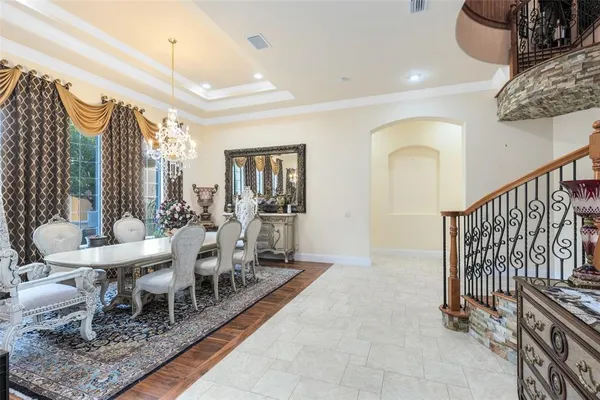 a view of a dining room with furniture large windows and wooden floor