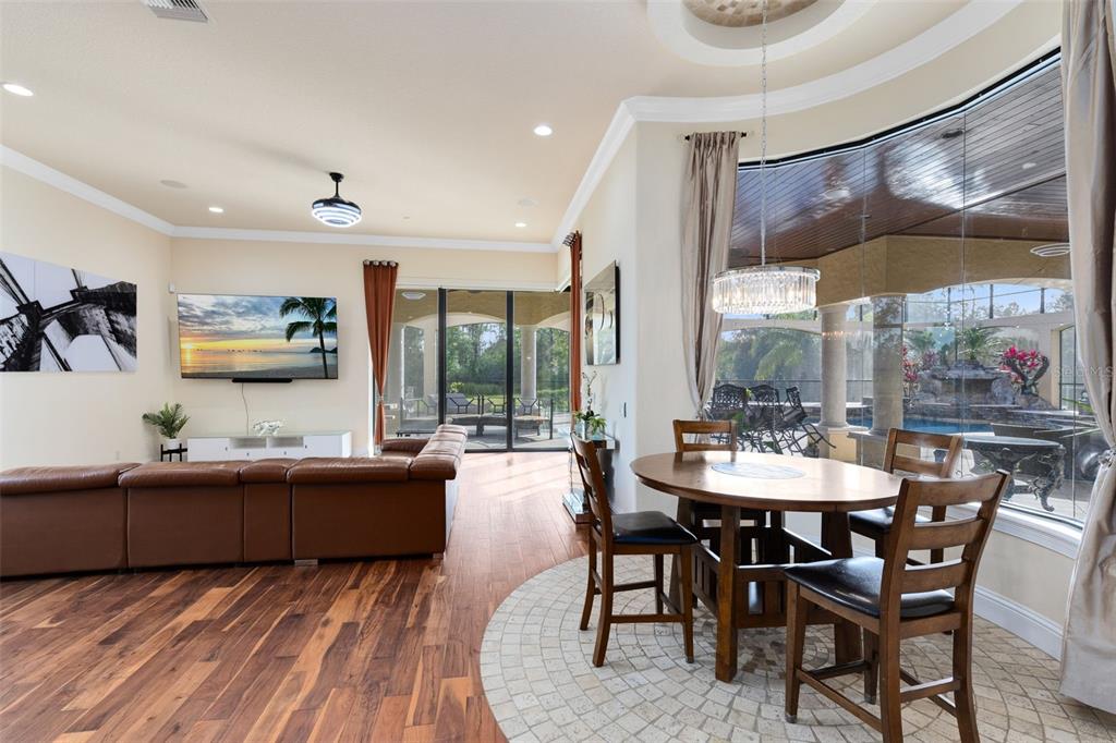 5300 Carson Street St. Cloud, FL 34771 - Photo 14 of 59 a view of a dining room with furniture large windows and wooden floor