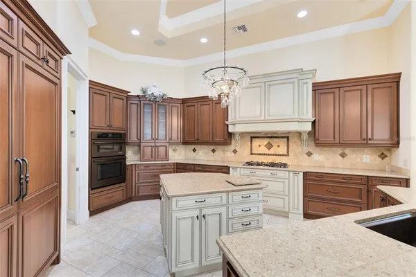 a living room with furniture kitchen view and a large window