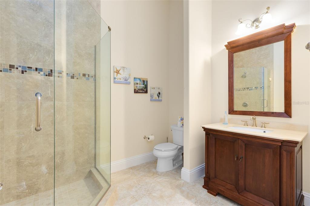 5300 Carson Street St. Cloud, FL 34771 - Photo 37 of 59 a bathroom with a double vanity sink toilet mirror and shower