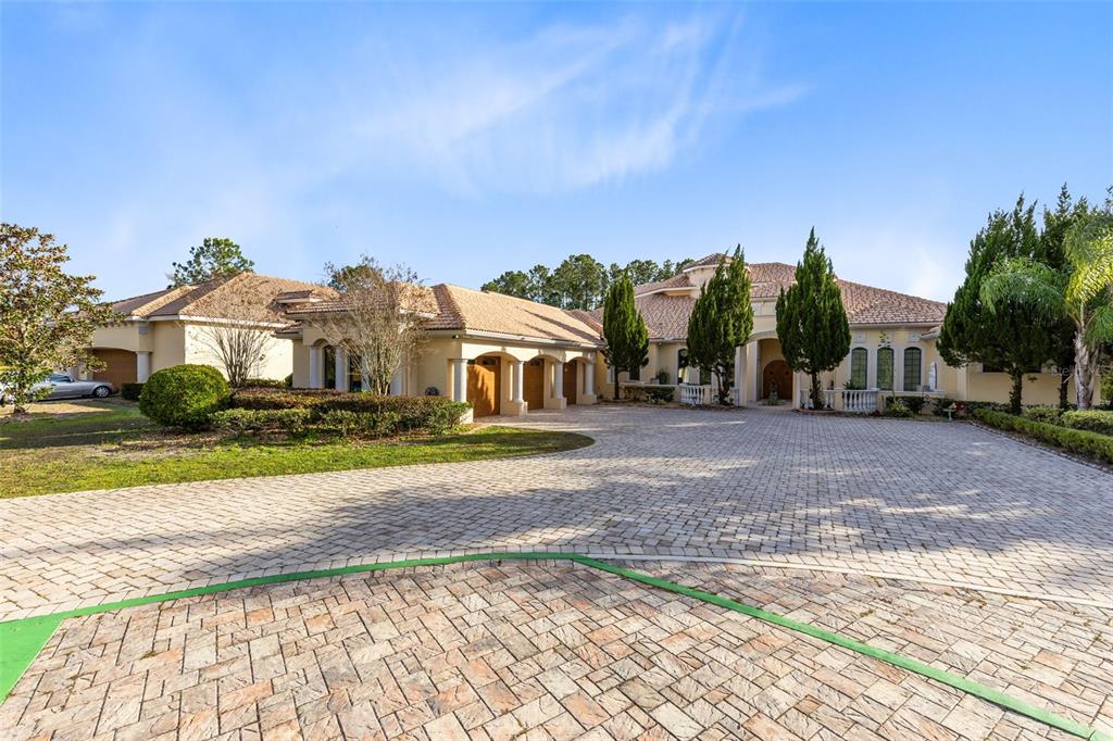 5300 Carson Street St. Cloud, FL 34771 - Photo 4 of 59 a view of a large house with a big yard and large trees