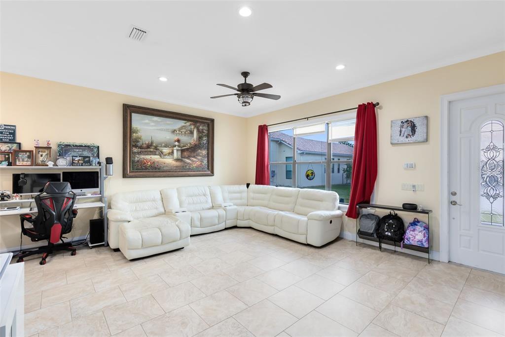 5300 Carson Street St. Cloud, FL 34771 - Photo 49 of 59 a living room with furniture and a flat screen tv