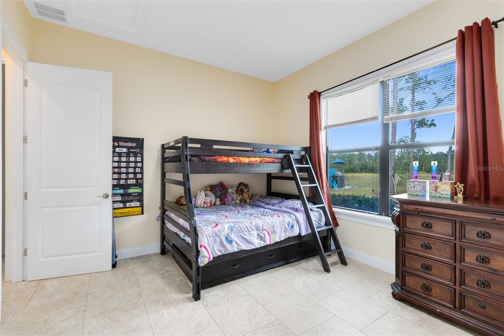 5300 Carson Street St. Cloud, FL 34771 - Photo 51 of 59 a bedroom with a bed and wooden floor