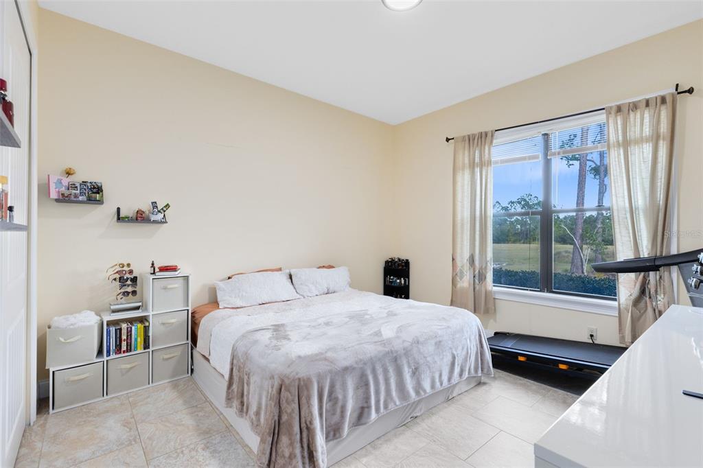 5300 Carson Street St. Cloud, FL 34771 - Photo 53 of 59 a bedroom with a bed and a large window