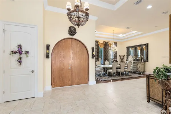 a living room with furniture a rug and a chandelier