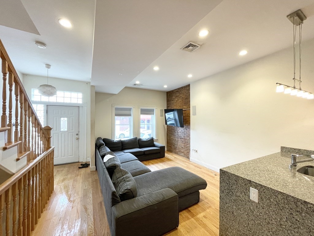 98 L Street, Unit STREET Boston, MA 02127 - Photo 5 of 19 a living room with furniture and a wooden floor