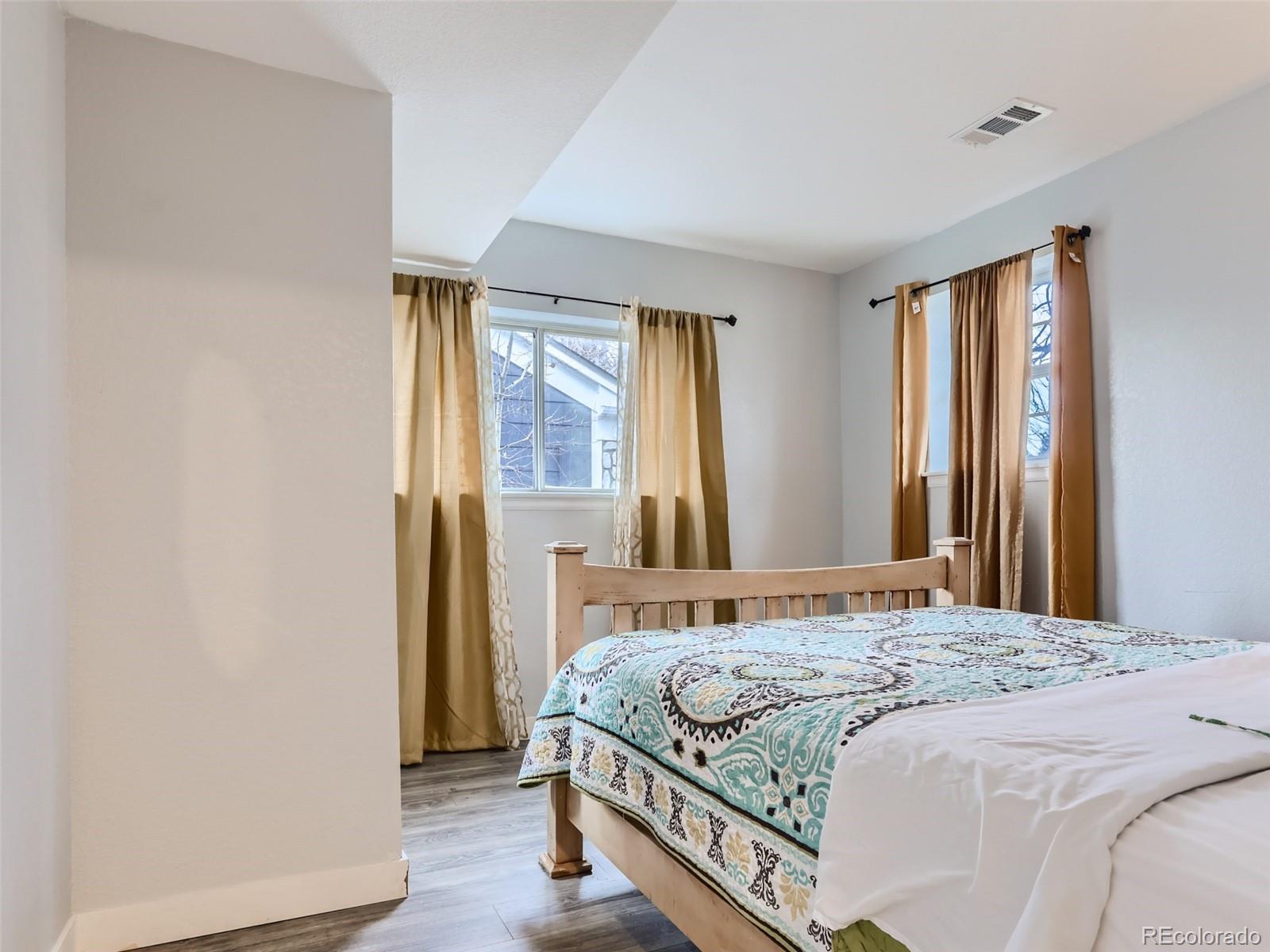 5941 South Perth Street Centennial, CO 80015 - Photo 19 of 28 a bedroom with a bed and a window