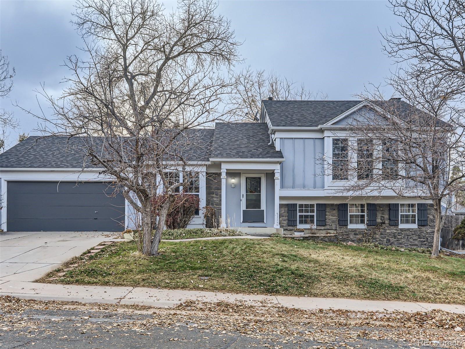 5941 South Perth Street Centennial, CO 80015 - Photo 2 of 28 a front view of a house with a yard