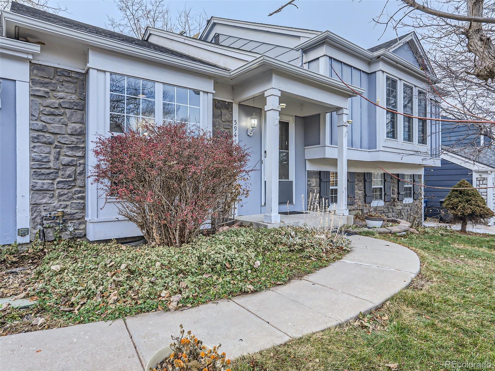 5941 South Perth Street Centennial, CO 80015 - Photo 3 of 28 front view of a house with a yard